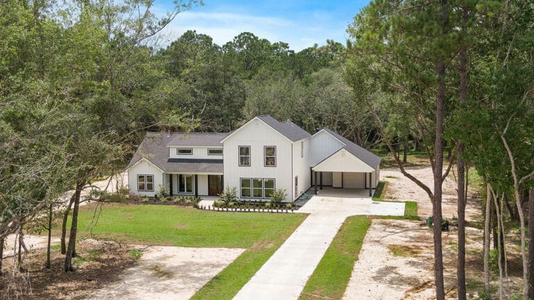 Newly completed modern farmhouse style custom home with attached carport/garage on a wooded estate lot in Wingfield Estates, Covington LA